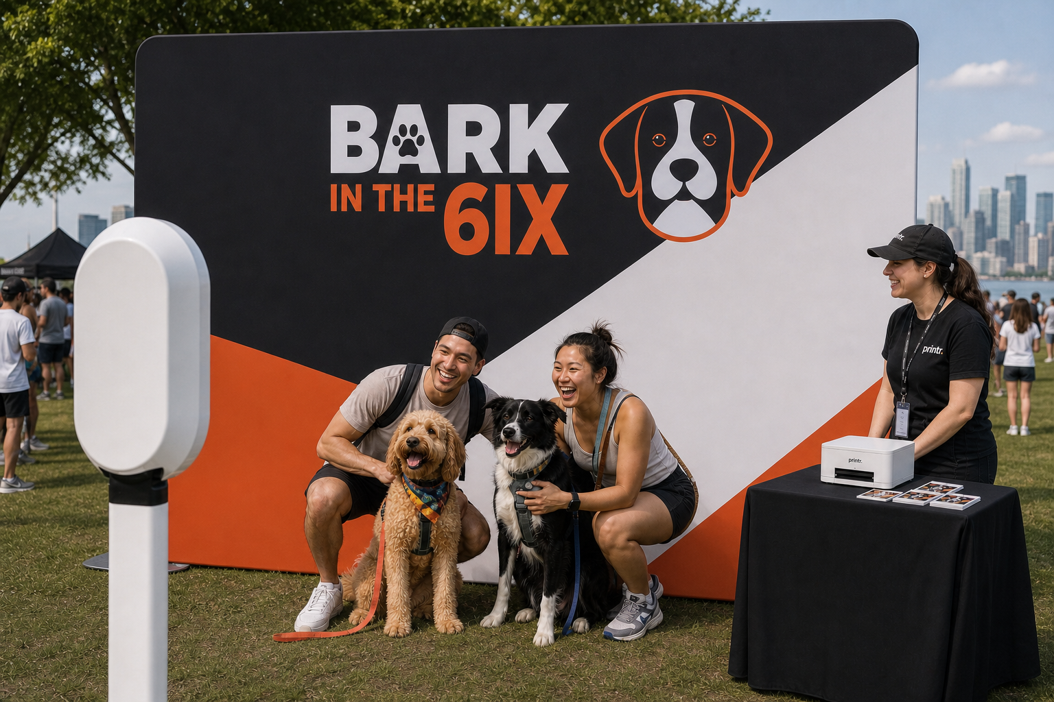 Friends posing with their dogs at a staffed Bark in the 6IX photobooth